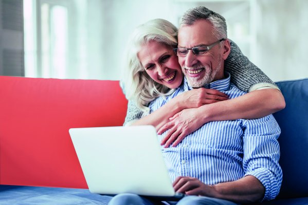 Couple de seniors heureux; la femme étreint son partenaire de l’arrière